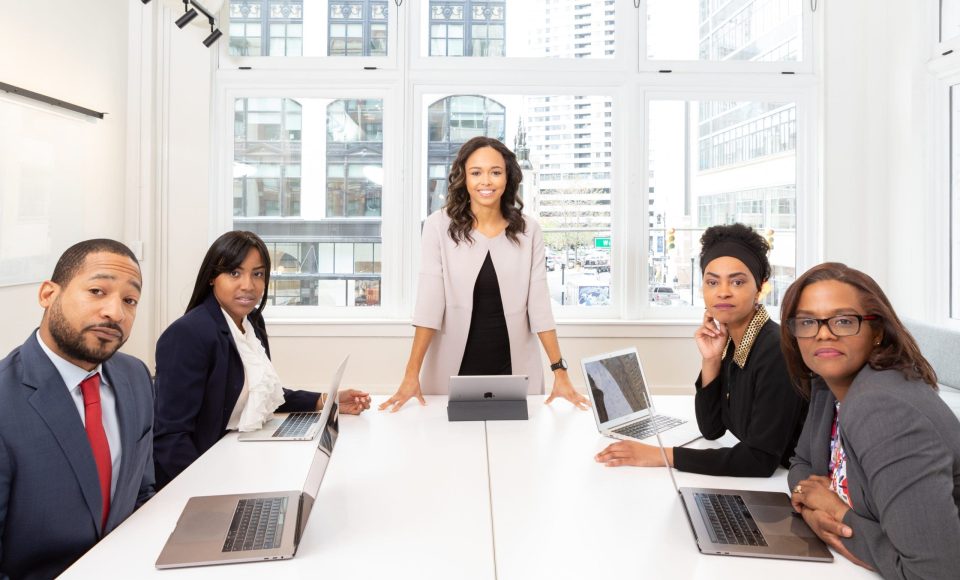 woman-standing-on-the-center-table-with-four-people-on-the-1367271